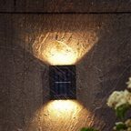 Schwarze Solar-LED-Wandleuchte mit warmweißem Licht nach oben und unten