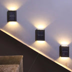 Schwarze Solar-LED-Wandleuchte mit warmweißem Licht nach oben und unten